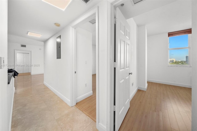 hallway with light hardwood / wood-style flooring