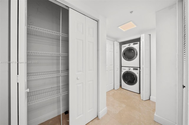 laundry area with stacked washer / drying machine