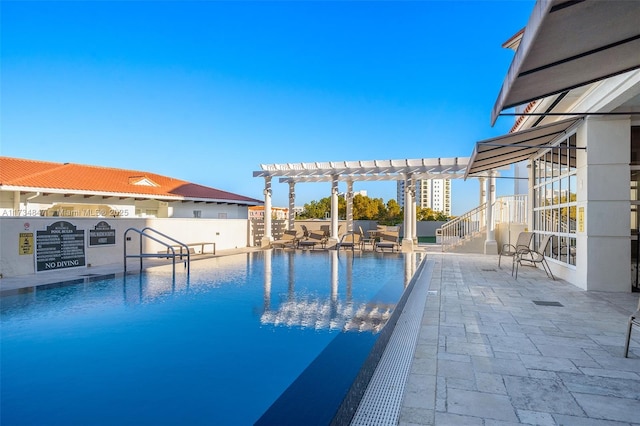 view of swimming pool with a pergola and a patio