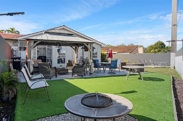 back of property featuring a gazebo, an outdoor living space with a fire pit, and a patio