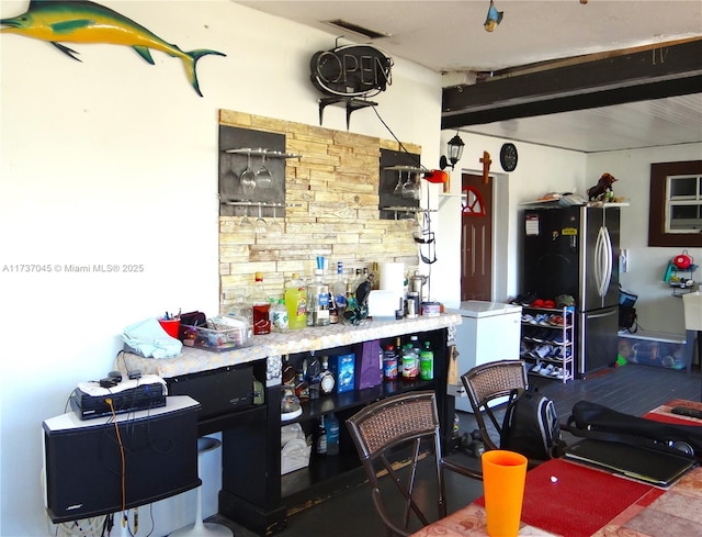 garage featuring stainless steel refrigerator and refrigerator