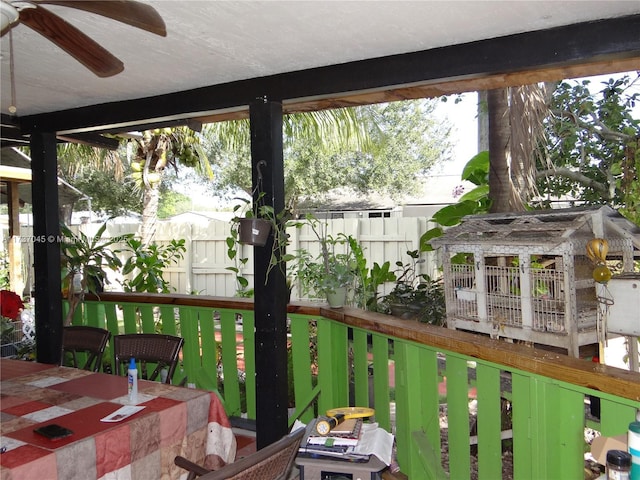 sunroom / solarium featuring ceiling fan