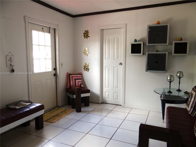 foyer entrance featuring light tile patterned flooring and ornamental molding