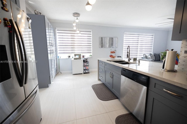 kitchen featuring appliances with stainless steel finishes, decorative light fixtures, sink, gray cabinetry, and crown molding