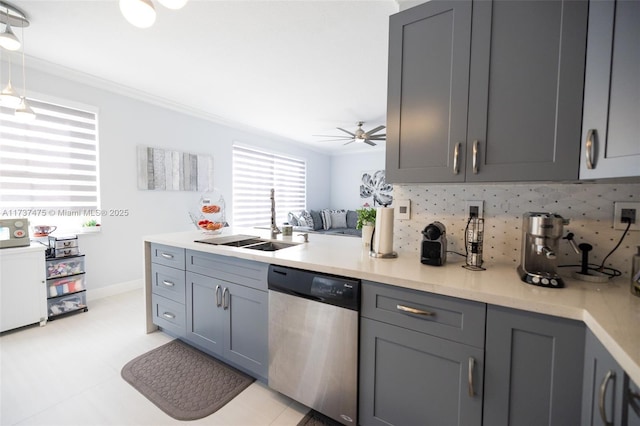 kitchen featuring dishwasher, sink, and gray cabinetry