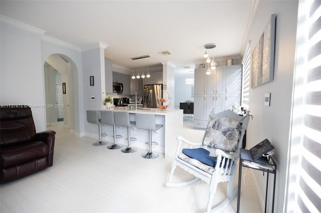 living room with ornamental molding and sink