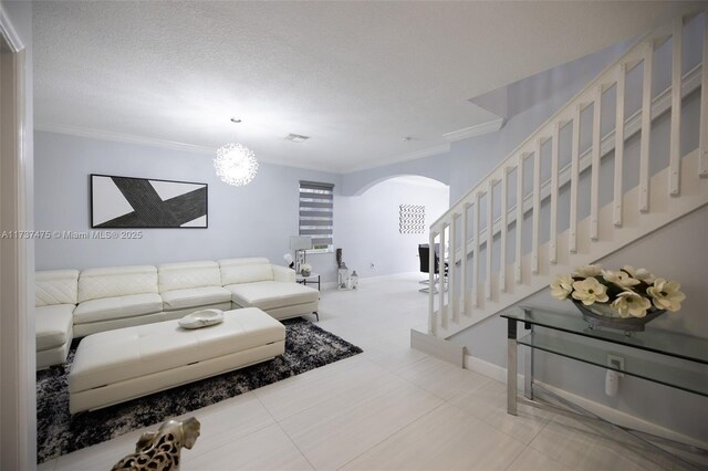 living room featuring tile patterned flooring, crown molding, and a textured ceiling