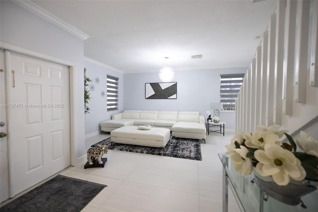 living room with ornamental molding and tile patterned floors