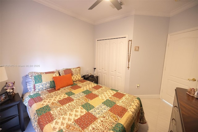 tiled bedroom featuring ornamental molding, ceiling fan, and a closet