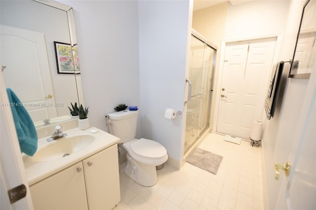 bathroom featuring a shower with door, vanity, and toilet