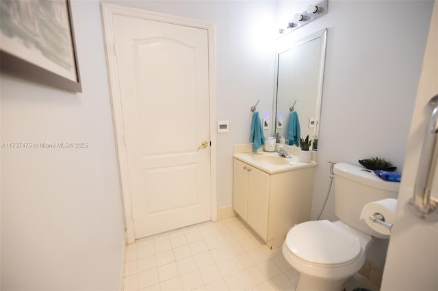 bathroom with vanity, tile patterned flooring, and toilet