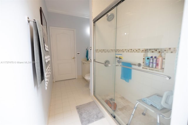 bathroom featuring an enclosed shower, tile patterned flooring, ornamental molding, and toilet