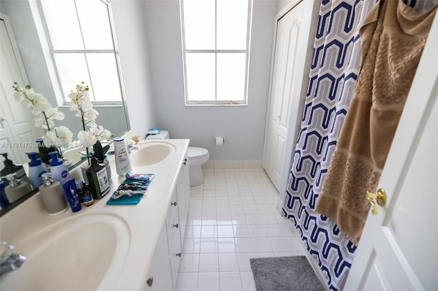 bathroom featuring tile patterned floors, vanity, and toilet