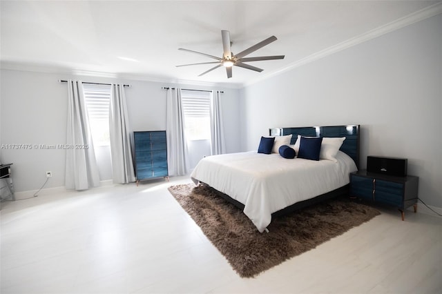 bedroom with ornamental molding and ceiling fan