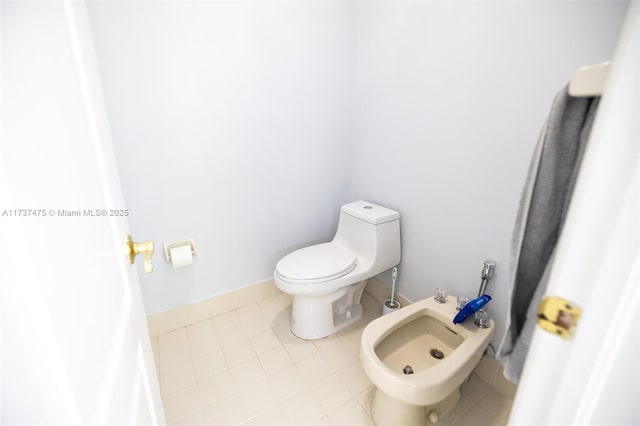 bathroom featuring a bidet, tile patterned floors, and toilet