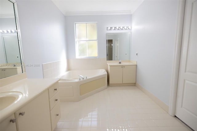 bathroom with tile patterned flooring, crown molding, a tub, and vanity