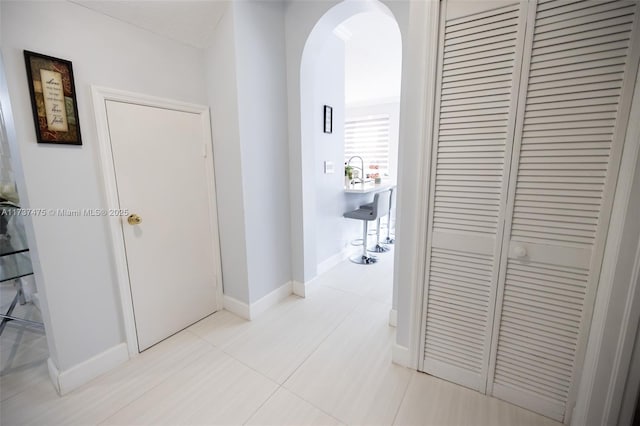 hallway featuring light tile patterned floors