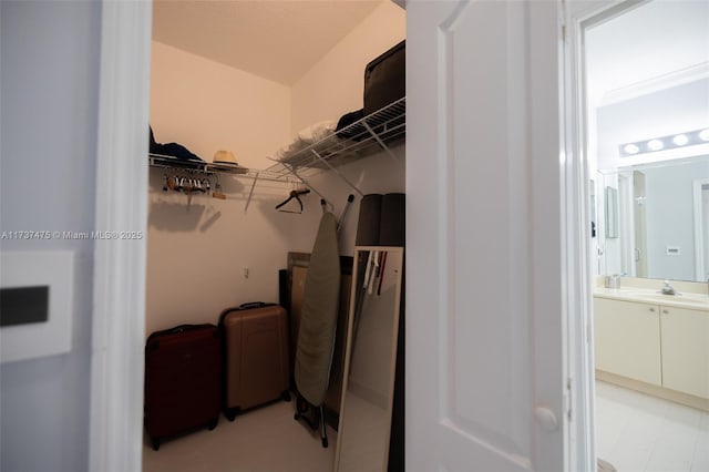 walk in closet featuring sink