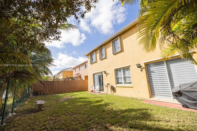 rear view of house with a lawn