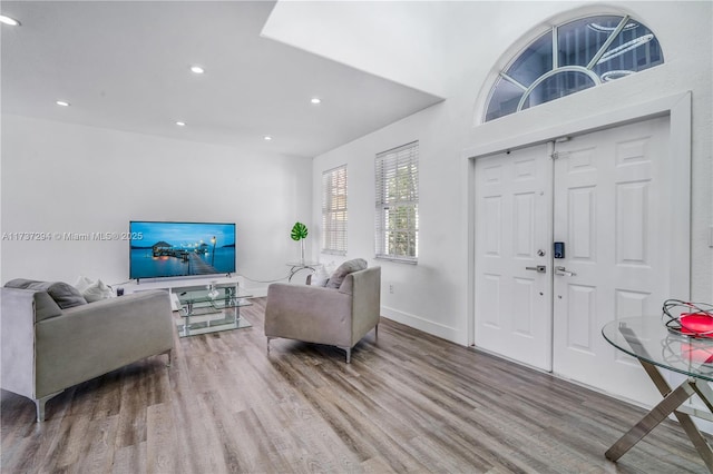 interior space featuring recessed lighting, baseboards, and wood finished floors