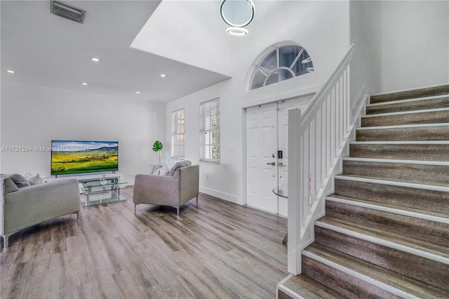 foyer featuring recessed lighting, visible vents, stairway, and wood finished floors