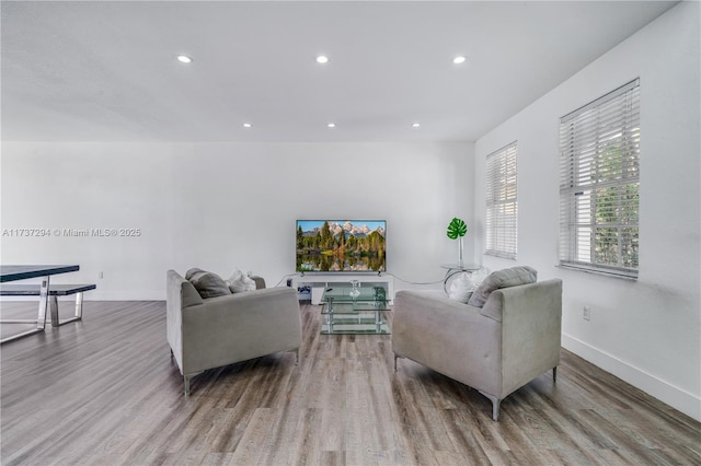 living room featuring recessed lighting, wood finished floors, and baseboards