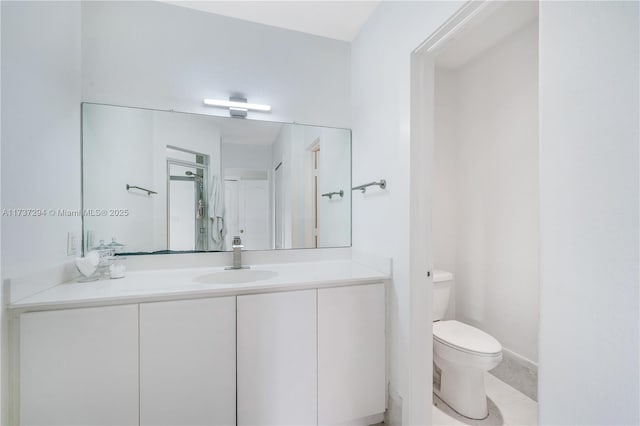 bathroom featuring vanity, tile patterned flooring, and toilet