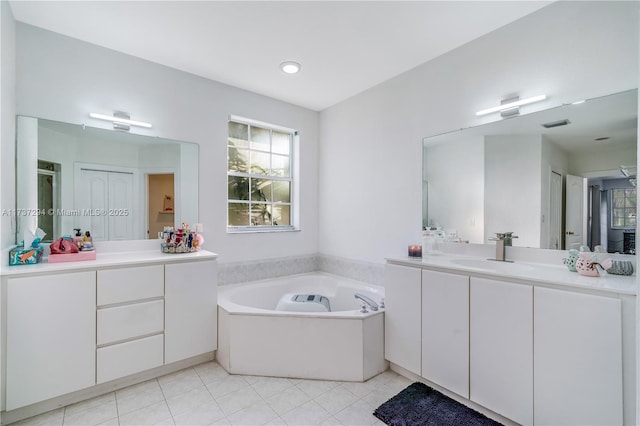 bathroom with tile patterned floors, vanity, and a bathtub