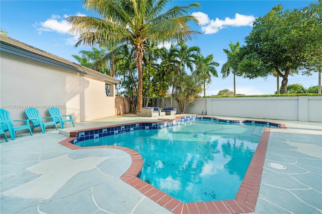 view of swimming pool with a patio