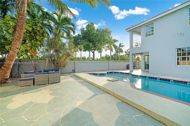 view of swimming pool featuring outdoor lounge area and a patio