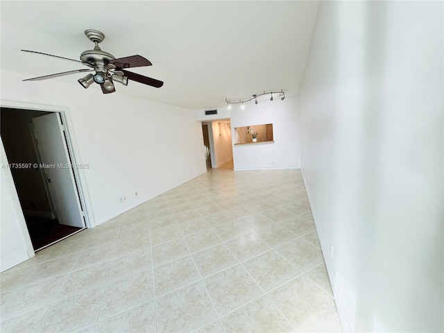 unfurnished room featuring light tile patterned floors, track lighting, and ceiling fan