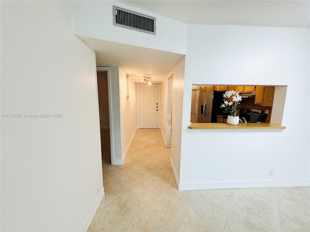 hallway with light tile patterned floors