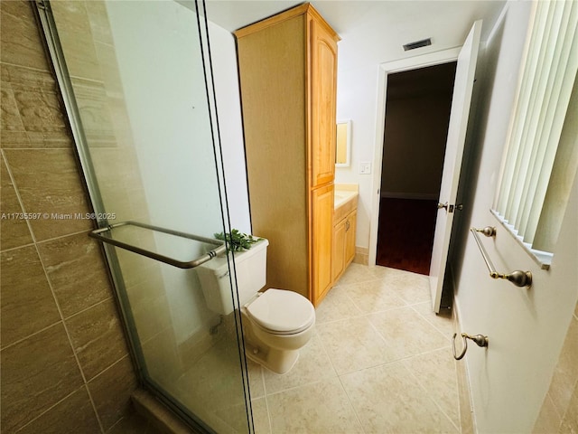 bathroom with vanity, tile patterned floors, toilet, and walk in shower