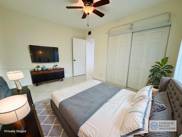 bedroom featuring light tile patterned floors, a closet, and ceiling fan