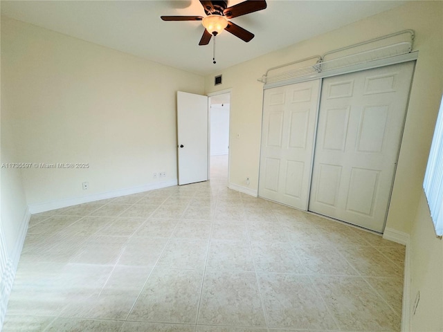 unfurnished bedroom featuring ceiling fan and a closet