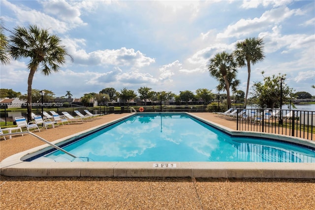 view of pool featuring a water view