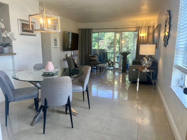 dining space with a textured ceiling, a notable chandelier, and tile patterned floors