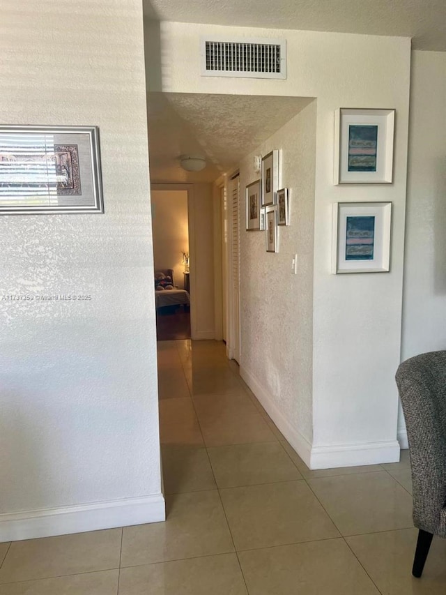 hall with tile patterned flooring