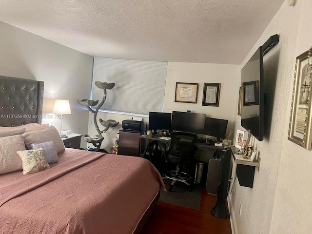 bedroom featuring hardwood / wood-style flooring and a textured ceiling