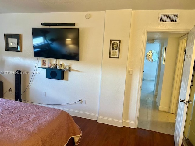 bedroom with wood-type flooring