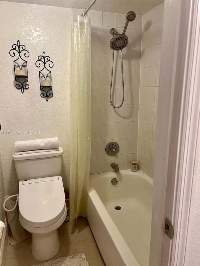 bathroom with tile patterned flooring, shower / tub combo with curtain, and toilet