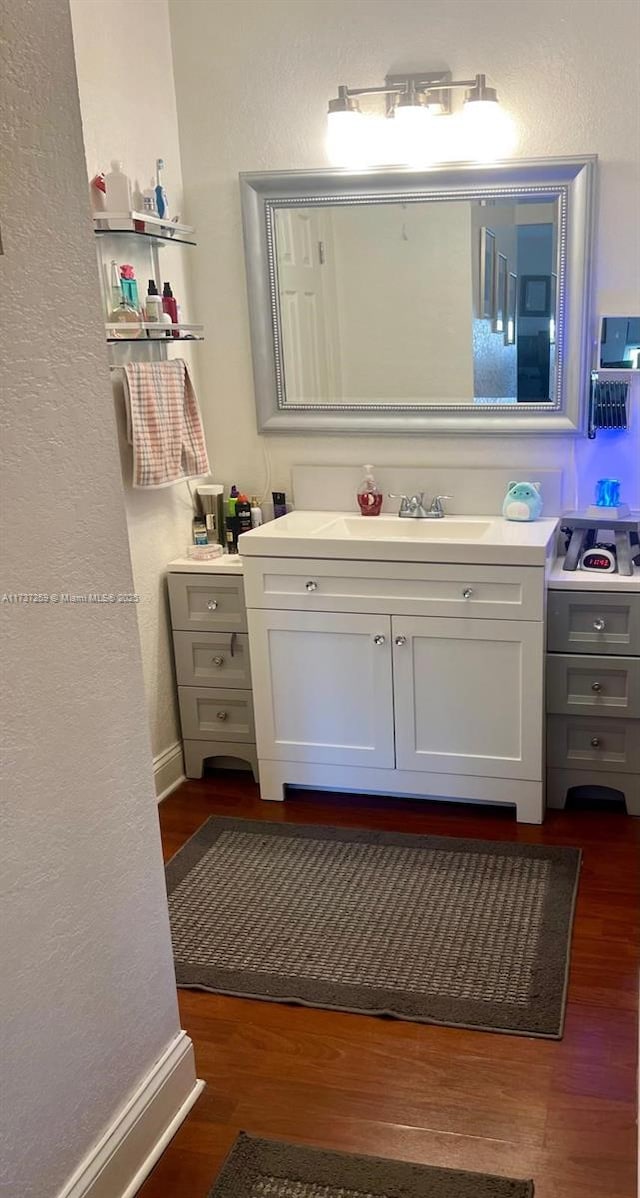 bathroom featuring hardwood / wood-style flooring and vanity