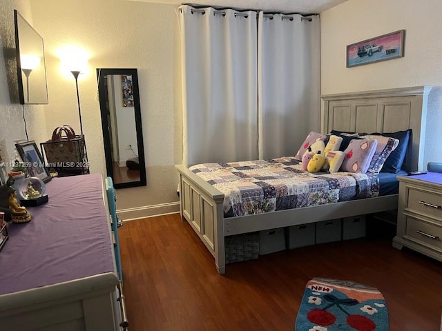 bedroom with dark wood-type flooring