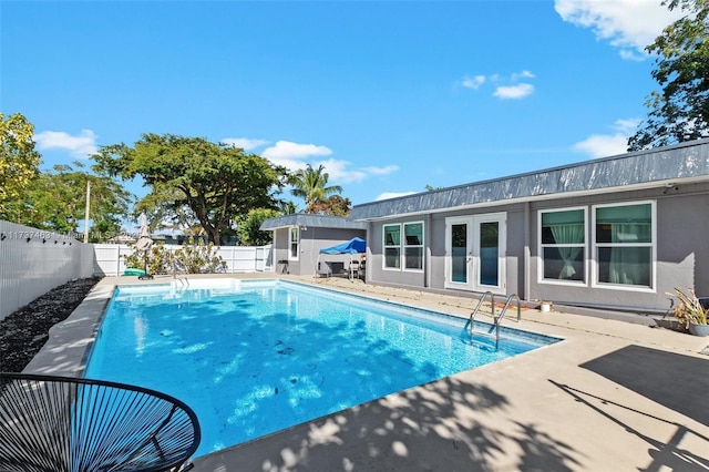 view of pool featuring a patio area and french doors