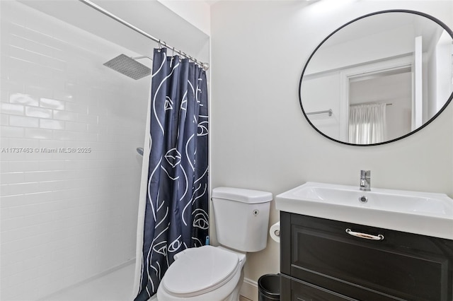 bathroom featuring vanity, toilet, and curtained shower