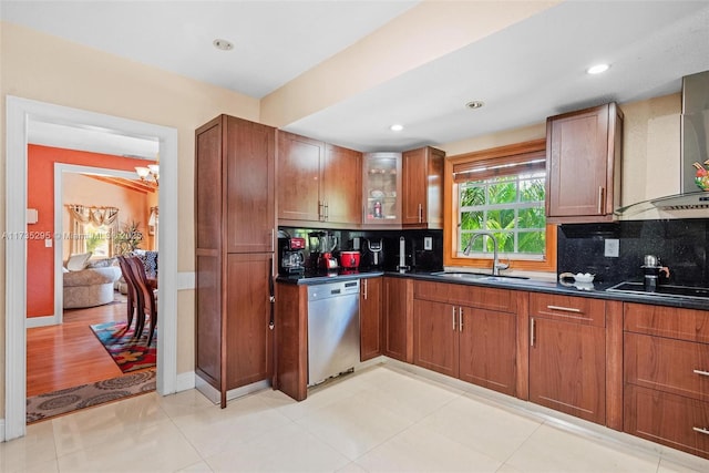 kitchen with decorative backsplash, dishwasher, dark countertops, black electric cooktop, and a sink