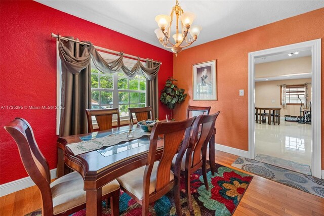 2039 SW 17th St, Miami, FL 33145 - dining space featuring a chandelier, a textured wall, wood finished floors, and baseboards