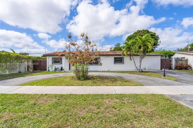 ranch-style home featuring a front lawn