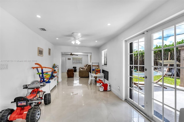 interior space with french doors and ceiling fan