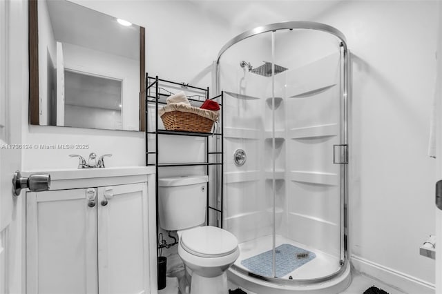 bathroom with vanity, toilet, and a shower with door